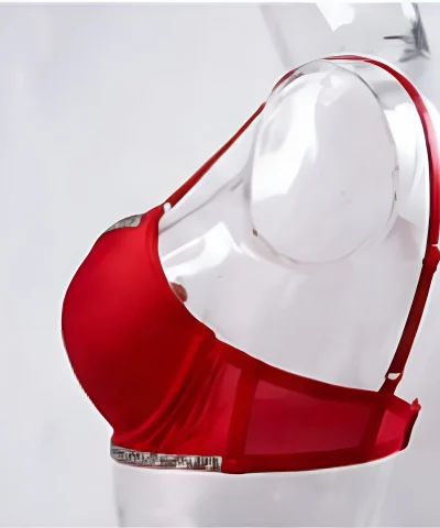 Side view of a red push-up bra on a mannequin showing the smooth seamless band, adjustable straps, and silver rhinestone under-bust trim.
